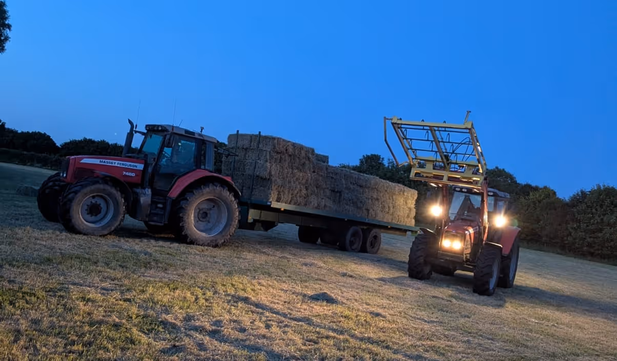 loading hay bales in the evening